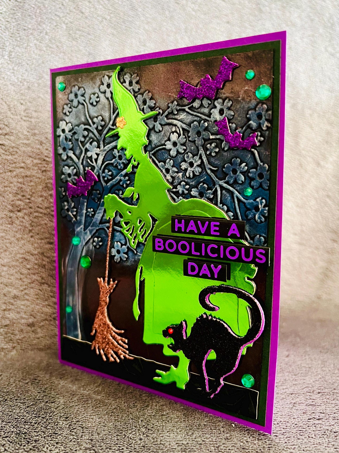 Green Silhouette Witch with Cat and Bats and Floral Tree Halloween Card