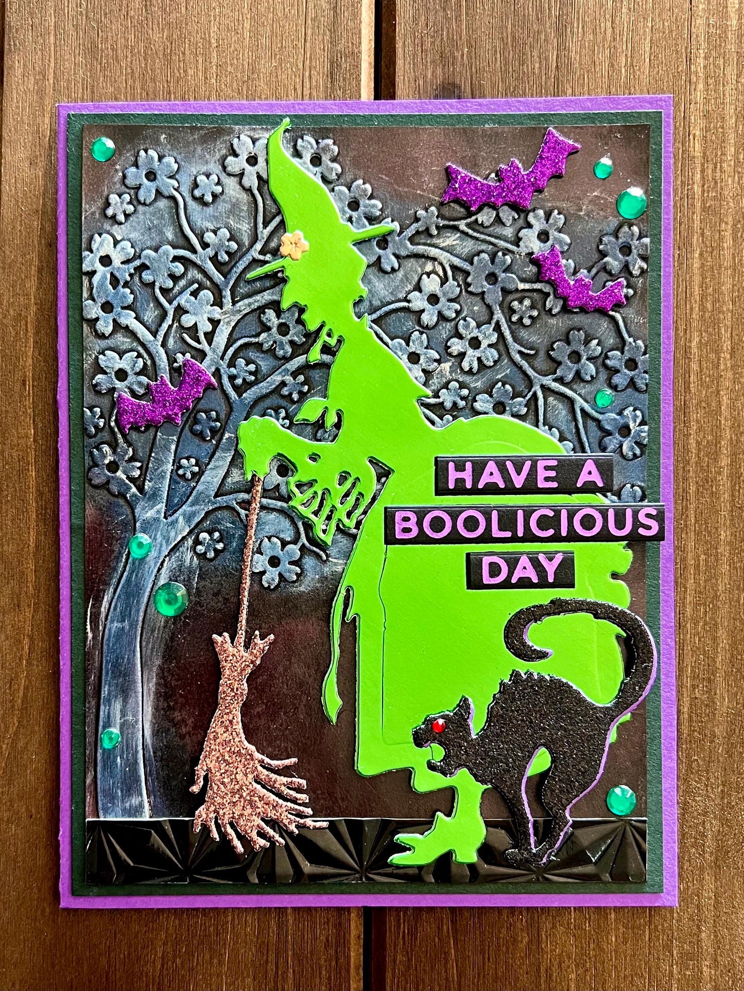 Green Silhouette Witch with Cat and Bats and Floral Tree Halloween Card