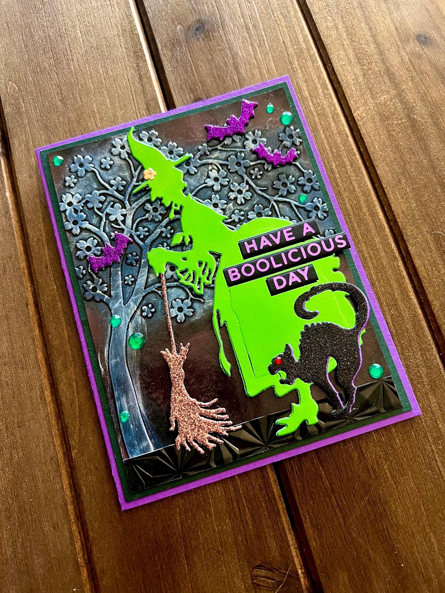 Green Silhouette Witch with Cat and Bats and Floral Tree Halloween Card