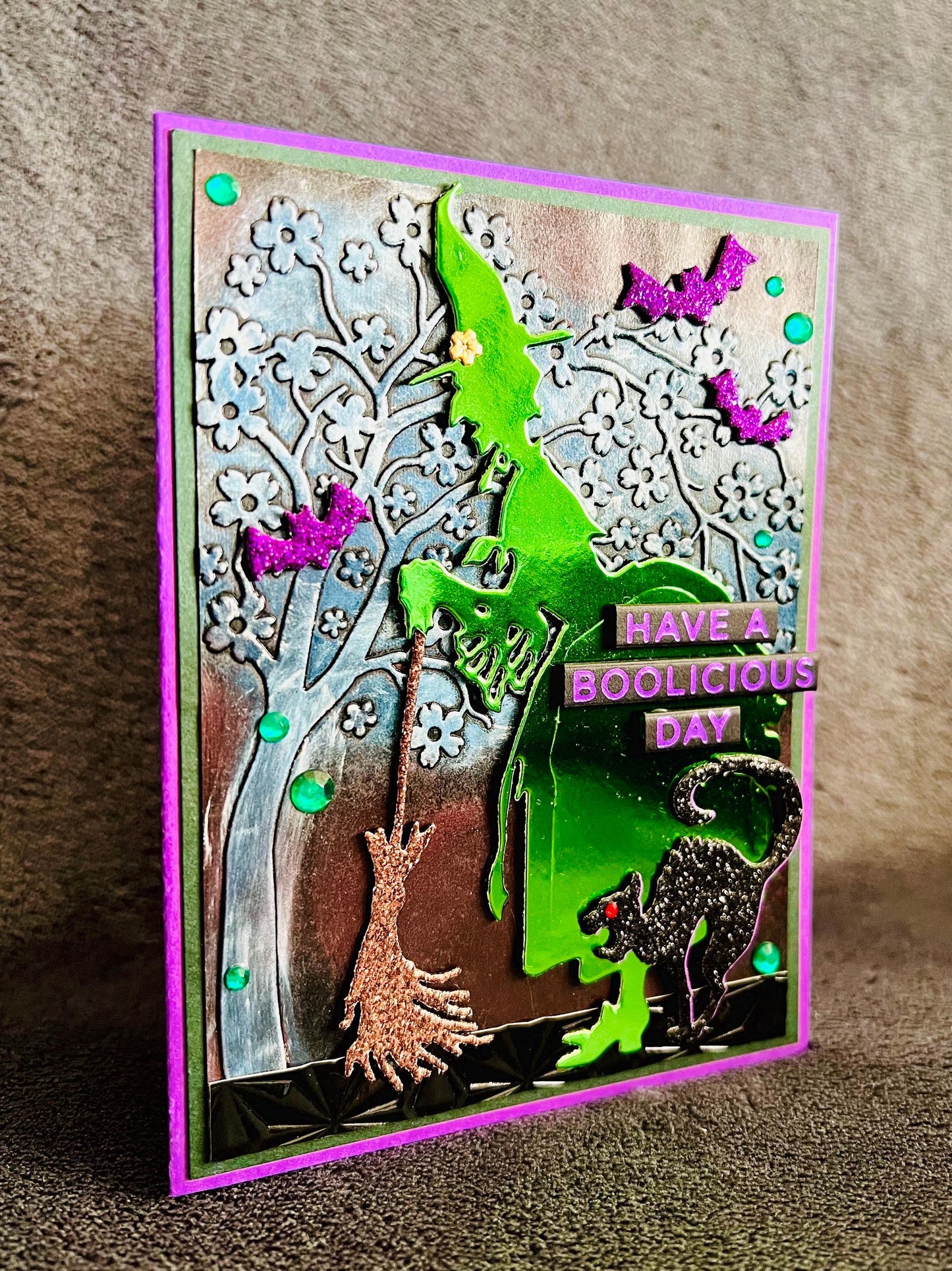 Green Silhouette Witch with Cat and Bats and Floral Tree Halloween Card