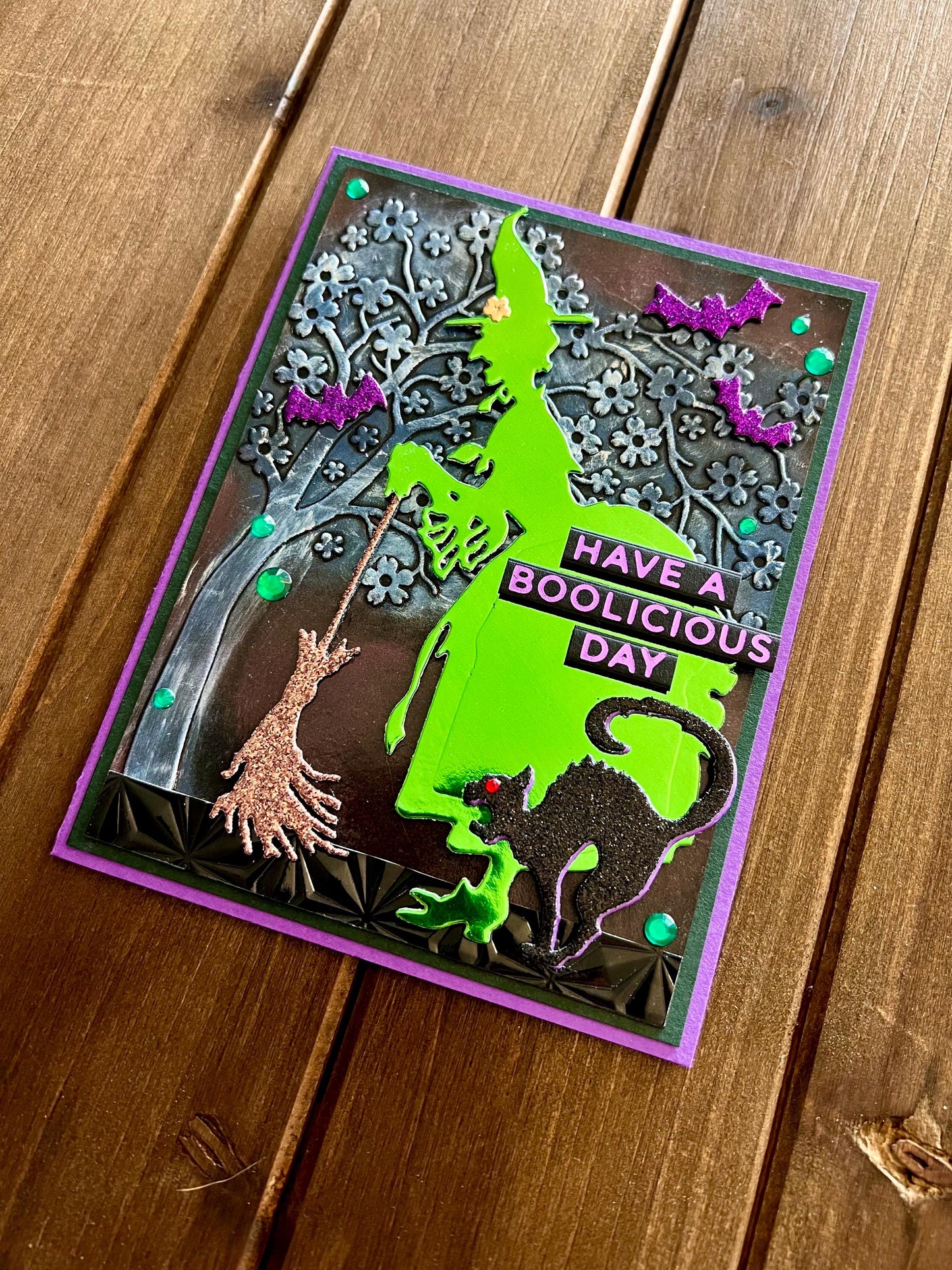 Green Silhouette Witch with Cat and Bats and Floral Tree Halloween Card