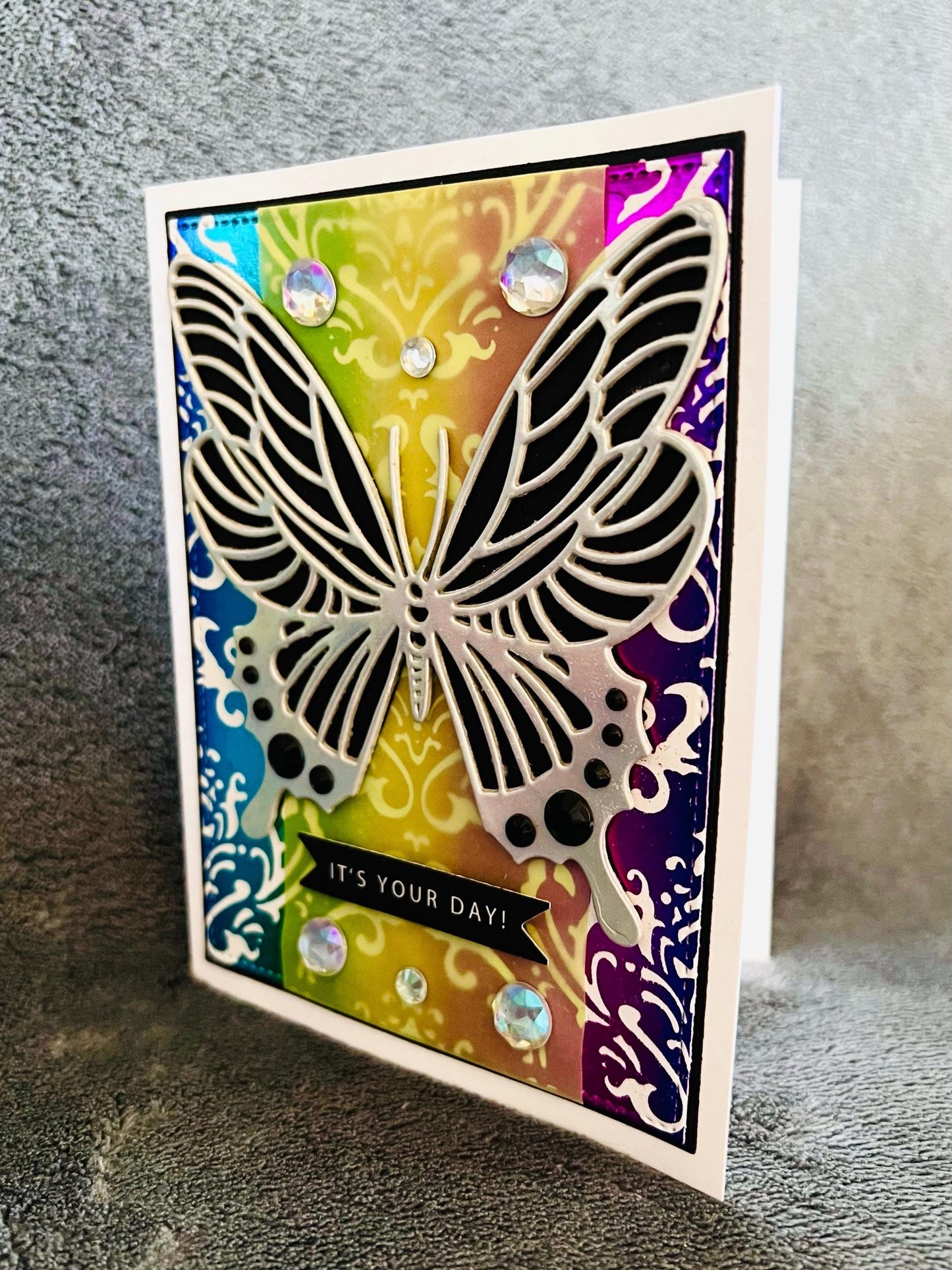 Silver Butterfly on Foiled Rainbow Damask Background It’s Your Day Card